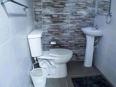 a bathroom with a toilet and a sink at Malecon Cozy - Premium Plus 12 in Santo Domingo