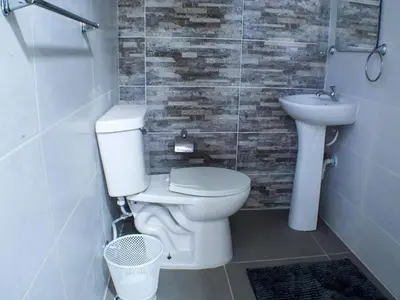 a bathroom with a toilet and a sink at Malecon Cozy - Premium Plus 16 in Santo Domingo
