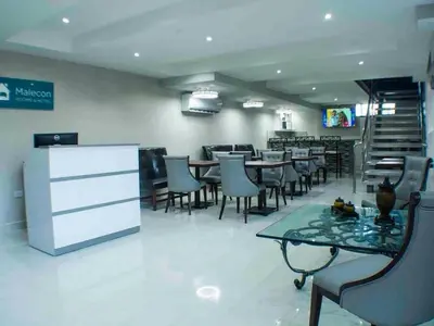 a dining room with tables and chairs in a restaurant at Malecon Cozy - Premium Plus 11 in Santo Domingo