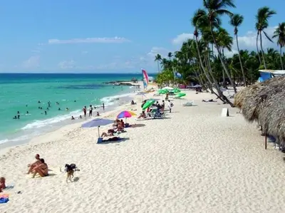 a group of people on a beach with the ocean at Beautiful Apt Dominicus Bayahibe, Walk To Beach! in La Laguna