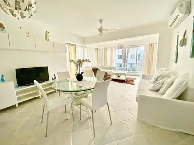 a living room with a glass table and a couch at Beautiful Apt Dominicus Bayahibe, Walk To Beach! in La Laguna
