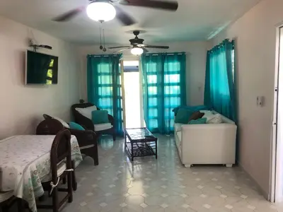 a living room with a bed and a couch at La Gaviota A3 in Juan Dolio