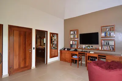 a living room with a desk and a television at Las Terrenas Front Beach And Garden Villa with private staff in Las Terrenas