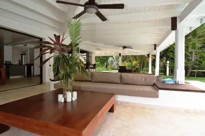 a living room with a couch and a ceiling fan at Las Terrenas Front Beach And Garden Villa with private staff in Las Terrenas