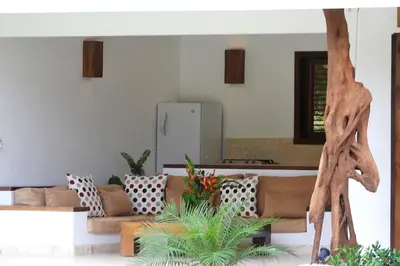 a living room with a couch and a giraffe statue at Las Terrenas Front Beach And Garden Villa with private staff in Las Terrenas