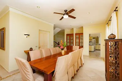 a dining room with a table and a ceiling fan at Exclusive Villa at Hideaway Beach in Cabarete