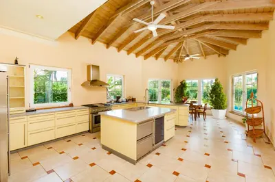 a large kitchen with a wooden ceiling at Exclusive Villa at Hideaway Beach in Cabarete