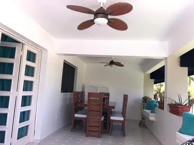a dining room with a ceiling fan and a table at La Gaviota B3 in Juan Dolio