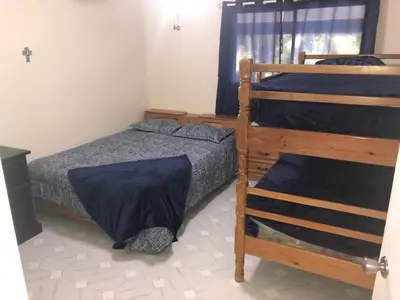 a bedroom with a bed and a bunk bed at La Gaviota B3 in Juan Dolio