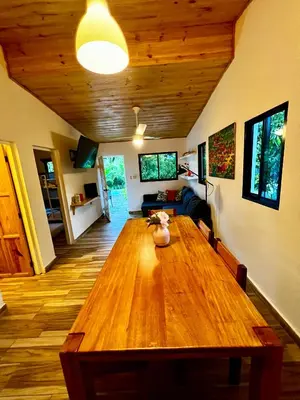 a large wooden table in a living room at Haus unter Palmen in Jarabacoa