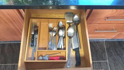 a drawer with utensils in a wooden cabinet at The biggest swimming pool in Sosua, frente a la piscina más grande en sosua in Sosúa