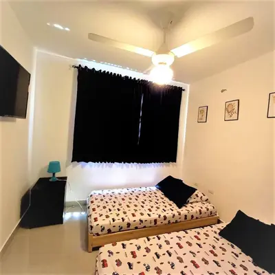 a bedroom with two beds and a window at Your Space piscina, parque infantil, 3 habitaciones , Res Breezes Santiago in Santiago de los Caballeros