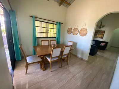 a dining room with a wooden table and chairs at Oasis de Paz 3 in Jarabacoa
