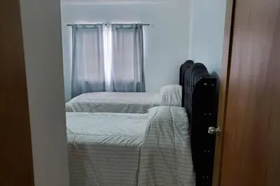 a bedroom with two beds and a window at Hanly Roger's Brand new place in San Felipe de Puerto Plata