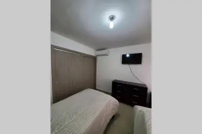 a small bedroom with a bed and a tv at Hanly Roger's Brand new place in San Felipe de Puerto Plata