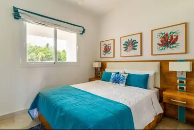 a bedroom with a large bed and a window at Apartamento Acceso Directo a la piscina A-108, A-120, A-117 y B-137 in Punta Cana