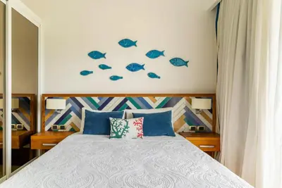 a bedroom with a bed with blue fish on the wall at Apartamento Acceso Directo a la piscina A-108, A-120, A-117 y B-137 in Punta Cana