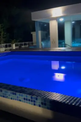 a blue swimming pool at night with a house at Best ocean view Sosua-Cabarete in Sosúa