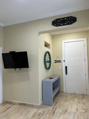 a living room with a flat screen tv on a wall at Best ocean view Sosua-Cabarete in Sosúa
