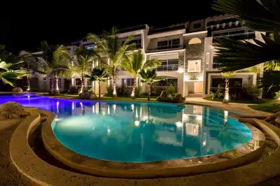 a swimming pool in front of a building at night at Apartamento Estrella Dominicus in La Laguna