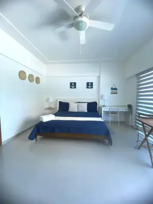 a bedroom with a bed and a ceiling fan at Elegante Blue Marine Apartamento Juan Dolio in Juan Dolio