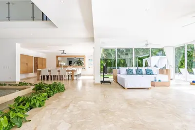 a living room with a couch and a table at Luxury Rentals in Punta Cana - Exclusive Waterfall Villa with Private Pool, BBQ, Maid, Golf in Punta Cana