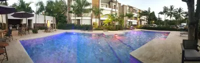a large swimming pool with blue lights in a building at Saman Terrace in Las Terrenas