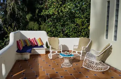 a group of chairs and a table on a porch at Villa directly on the beach, las Ballenas in Las Terrenas