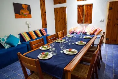 a dining table with chairs and a blue table cloth at Villa directly on the beach, las Ballenas in Las Terrenas