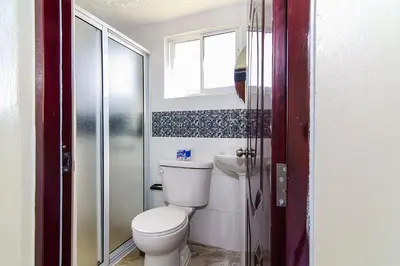 a small bathroom with a toilet and a window at Quiet 1 Bedroom Apartment Premium Wi-Fi 2 beds 15 minutes from the airport in La Viva