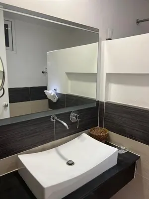 a bathroom with a white sink and a large mirror at Vista Mare Samana Amazing Views!! in Santa Bárbara de Samaná