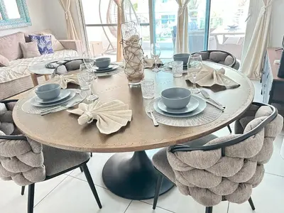 a wooden table with chairs and a dining room at Atmospheric apartment with a beautiful view of the swimming pool in Bayahibe