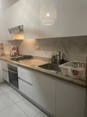 a kitchen counter with a sink and a stove at Atmospheric apartment with a beautiful view of the swimming pool in Bayahibe