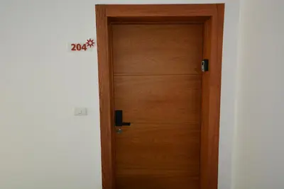 a wooden door in a room next to a wall at Atmospheric apartment with a beautiful view of the swimming pool in Bayahibe