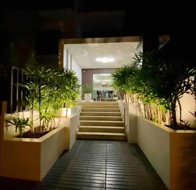 a hallway with stairs and potted plants in a building at Amazing Rooftop and Best View of the City in Santiago de los Caballeros