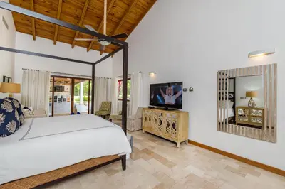 a bedroom with a bed and a television in it at Stunning Villa with Private Pool and Jacuzzi in Casa de Campo in La Romana