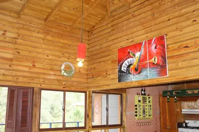a room with a wooden ceiling with a sign on the wall at Estancias Arroyazo in Constanza