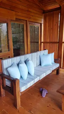 a bench with four pillows on it in a room at Estancias Arroyazo in Constanza