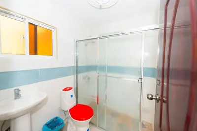 a bathroom with a shower and a sink at Modern Tropical 2-Bedroom Apartment with Terrace 300 Mbps Wi-Fi, power Generator in La Viva