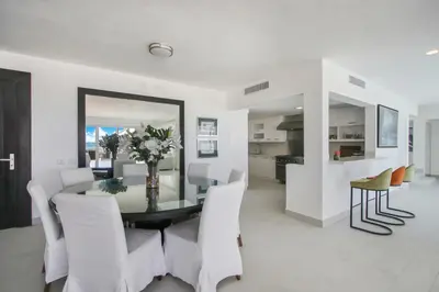 a white dining room with a table and chairs at Luxury Villa in Bávaro Just on the Beach in Punta Cana