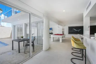a dining room and living room with a table and chairs at Luxury Villa in Bávaro Just on the Beach in Punta Cana