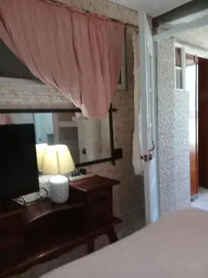 a bedroom with a bed and a desk with a lamp at Villa Julirous Rd, spa and aparthotel camp for vacationers in Boca Chica