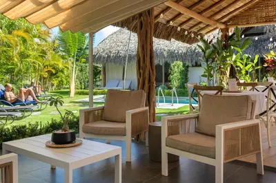 a patio at a resort with chairs and a table at TAKUMA BOUTIK HOTEL in Las Terrenas