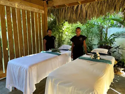 two men standing between two beds in a room at TAKUMA BOUTIK HOTEL in Las Terrenas