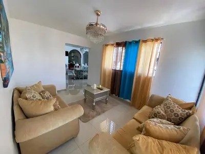 a living room with two couches and a table at Santiago City Center Huge nice Apartment to stay rooftop to enjoy the city view in Santiago de los Caballeros