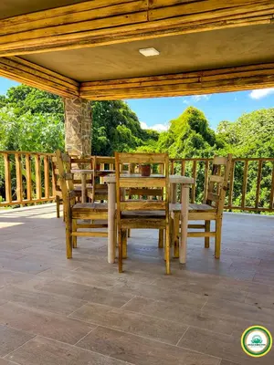 a patio with a table and chairs on a deck at Colina Buena vista A4 in Jarabacoa