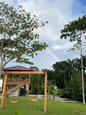 a rainbow in the sky over a playground at Colina Buena vista A4 in Jarabacoa