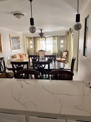 a living room with a table and chairs at Apartamento amueblado en Villa Olga in Santiago de los Caballeros