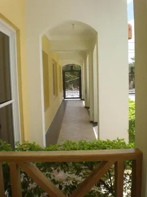 a hallway of a house with a hallway leading to a door at Vanilla House in Bayahibe