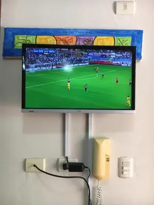 a flat screen tv hanging on a wall at Vanilla House in Bayahibe